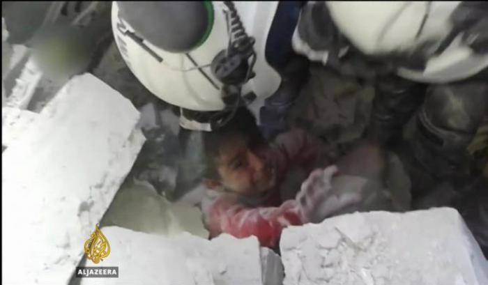 Un bambino restato sotto un bombardamento ad Aleppo