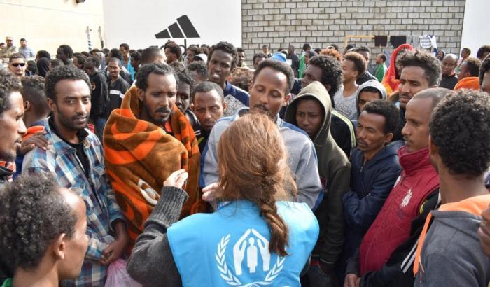 Un'operatrice di Unhcr con i migranti detenuti in Libia